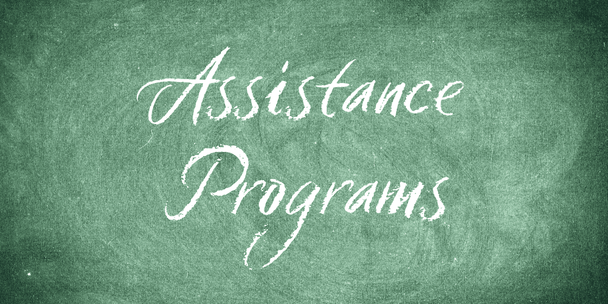 A chalkboard with the words "assistance programs" written on it